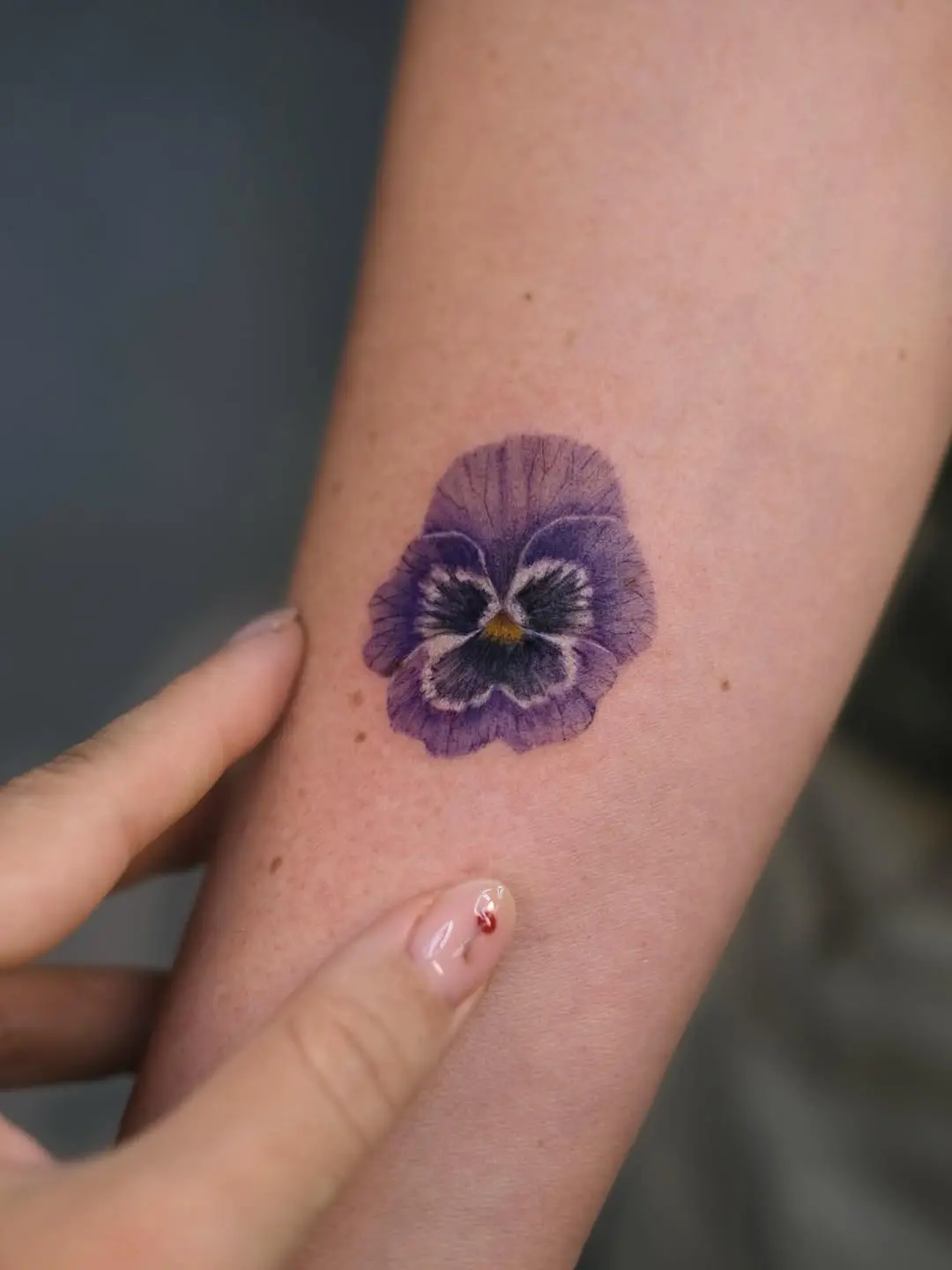 Stunning violet flower tattoo showcasing intricate details