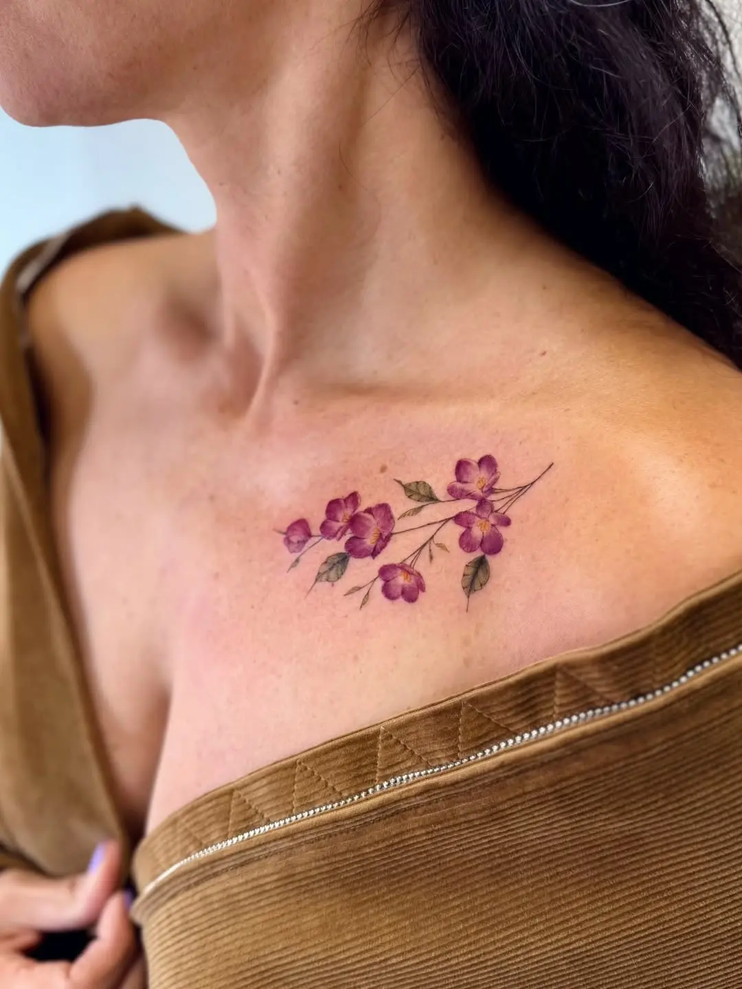 Elegant violet flower tattoo on shoulder