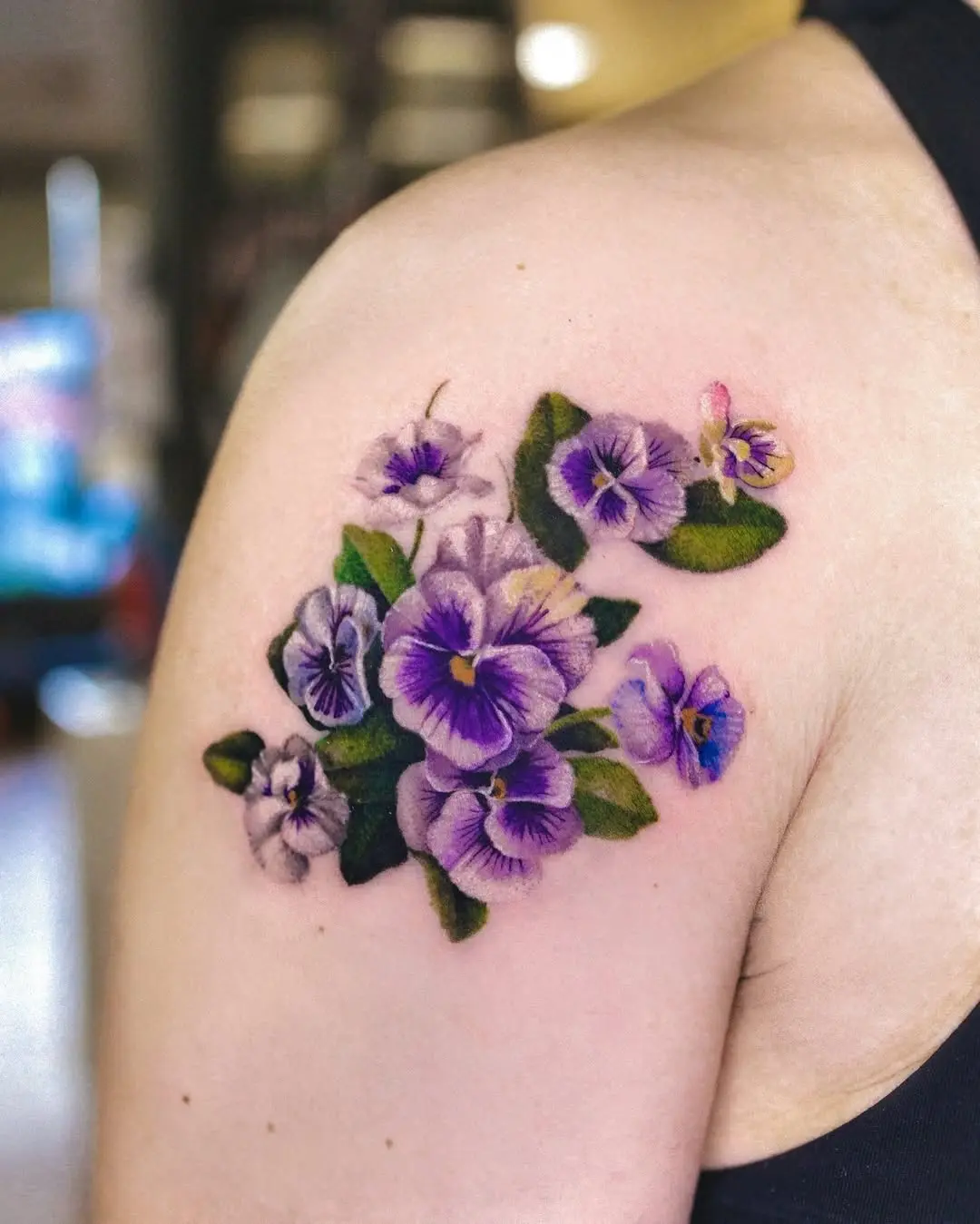 Vibrant violet flower tattoo showcases nature's beauty
