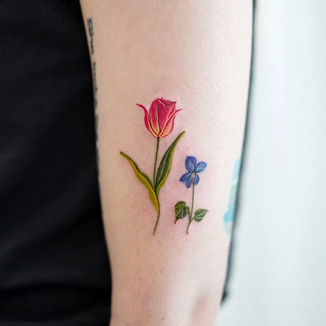 Delicate floral tattoos with a splash of violet