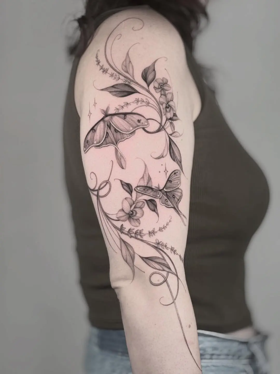 Elegant violet tattoo with floral and moth details