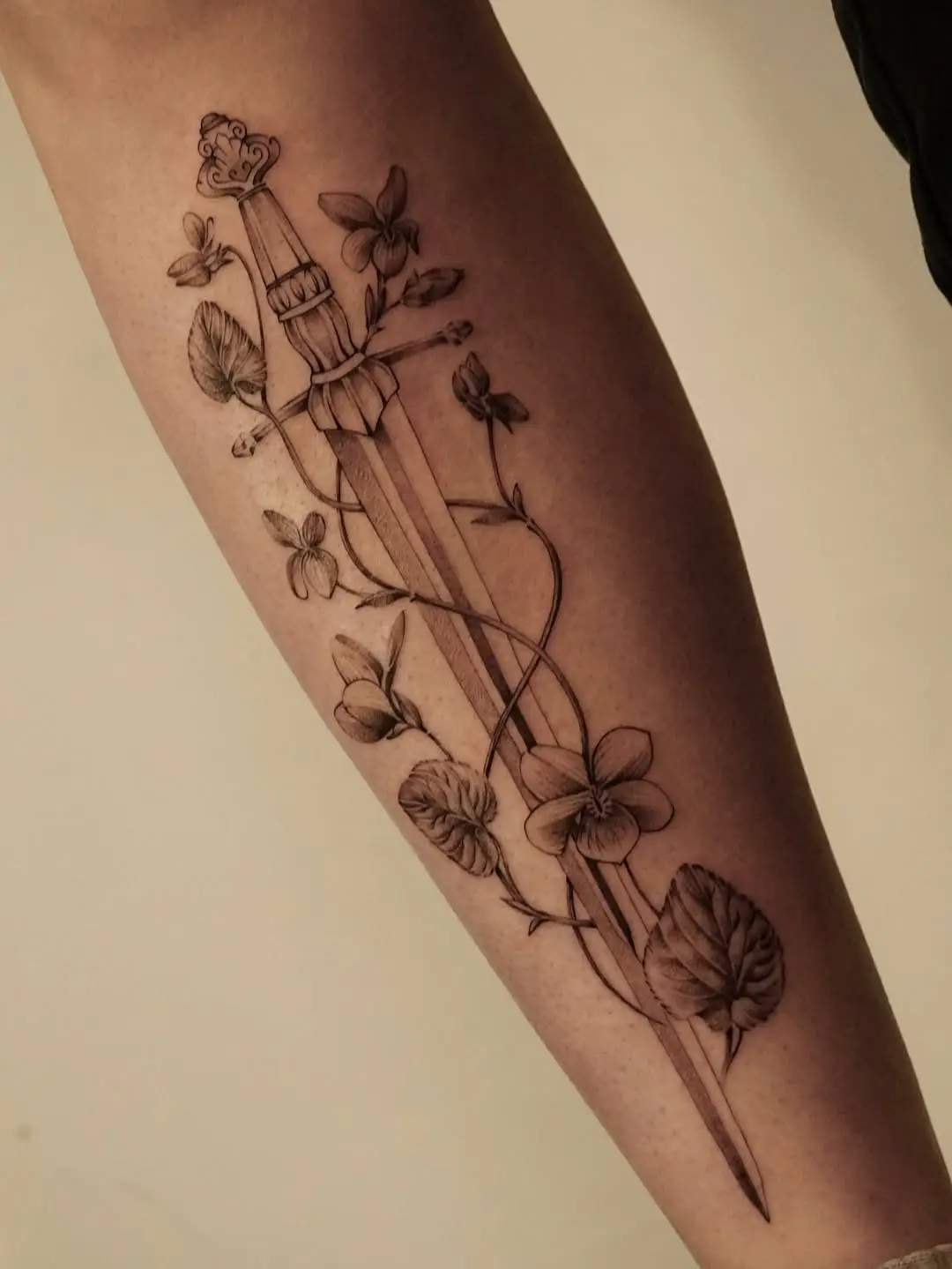 Delicate Violet Surrounding a Dagger Tattoo