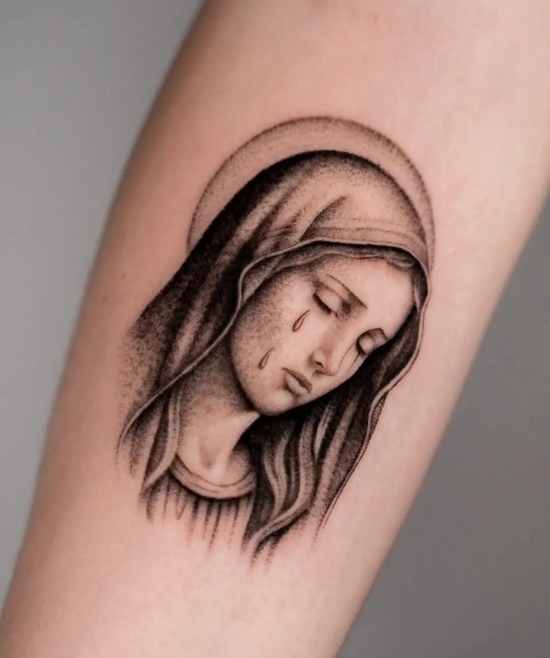 Expressive Virgin Mary Tattoo with Tear Detail