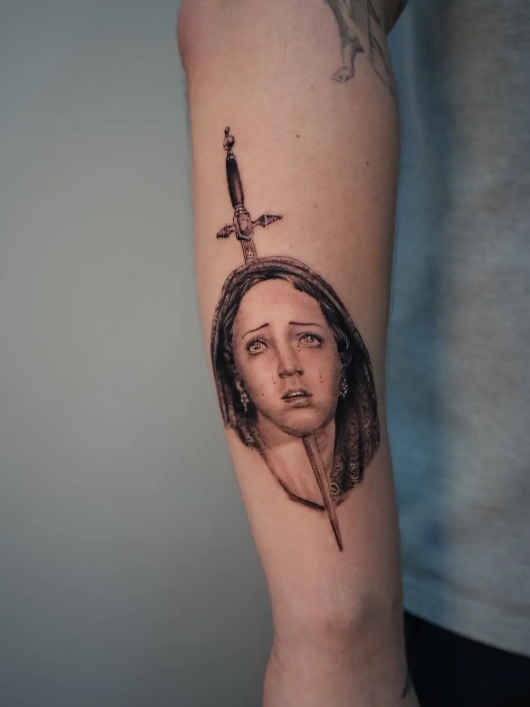 Dramatic Virgin Mary Tattoo with Sword