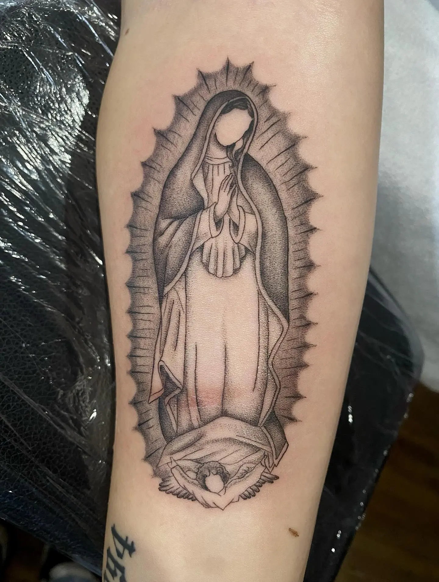 Artful Virgin Mary Tattoo with Detailed Shading