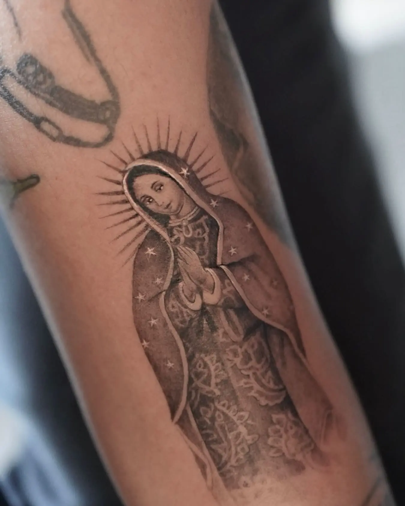 Elegant Virgin Mary Tattoo on Arm