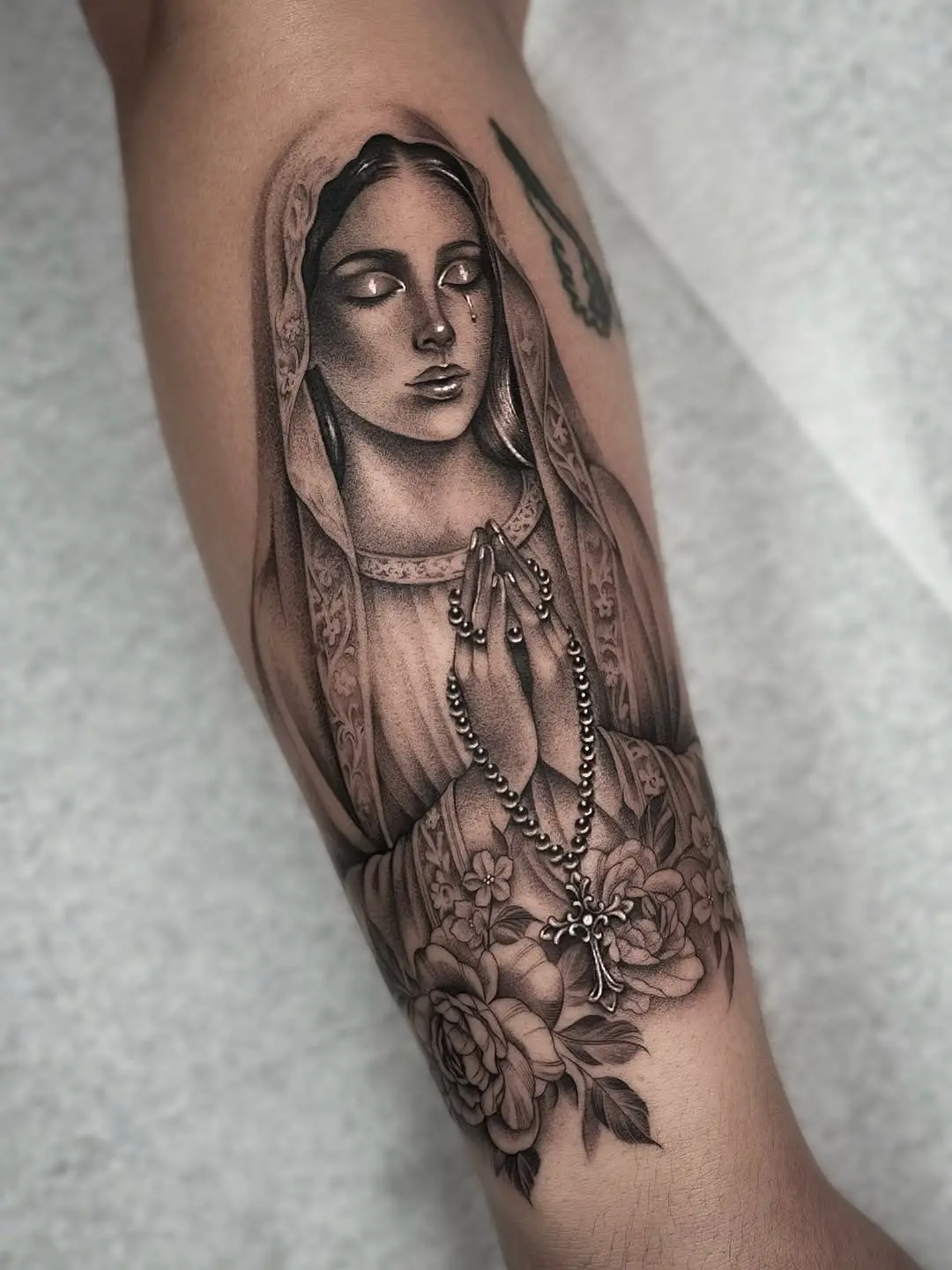 Stunning Virgin Mary Tattoo with Floral Elements
