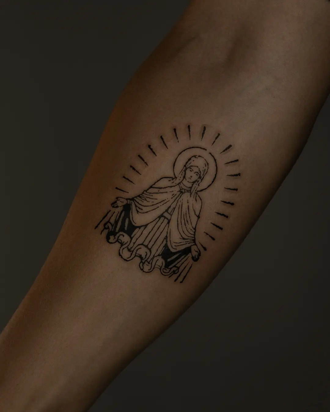Detailed Virgin Mary tattoo design in black ink