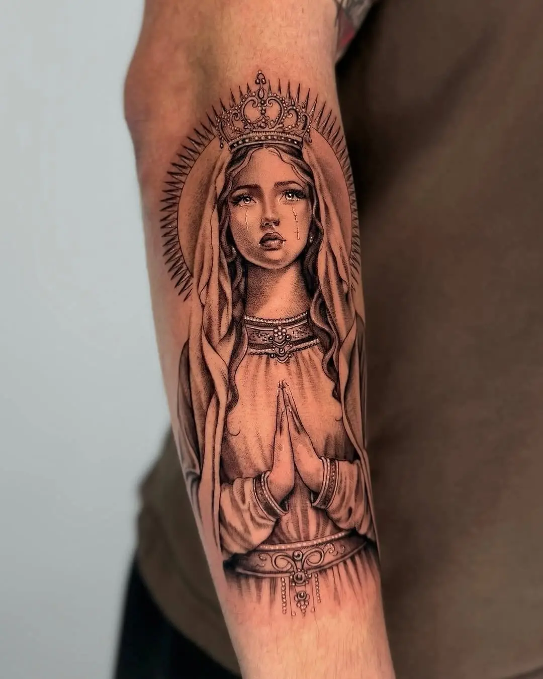 Beautiful detailed Virgin Mary tattoo on forearm