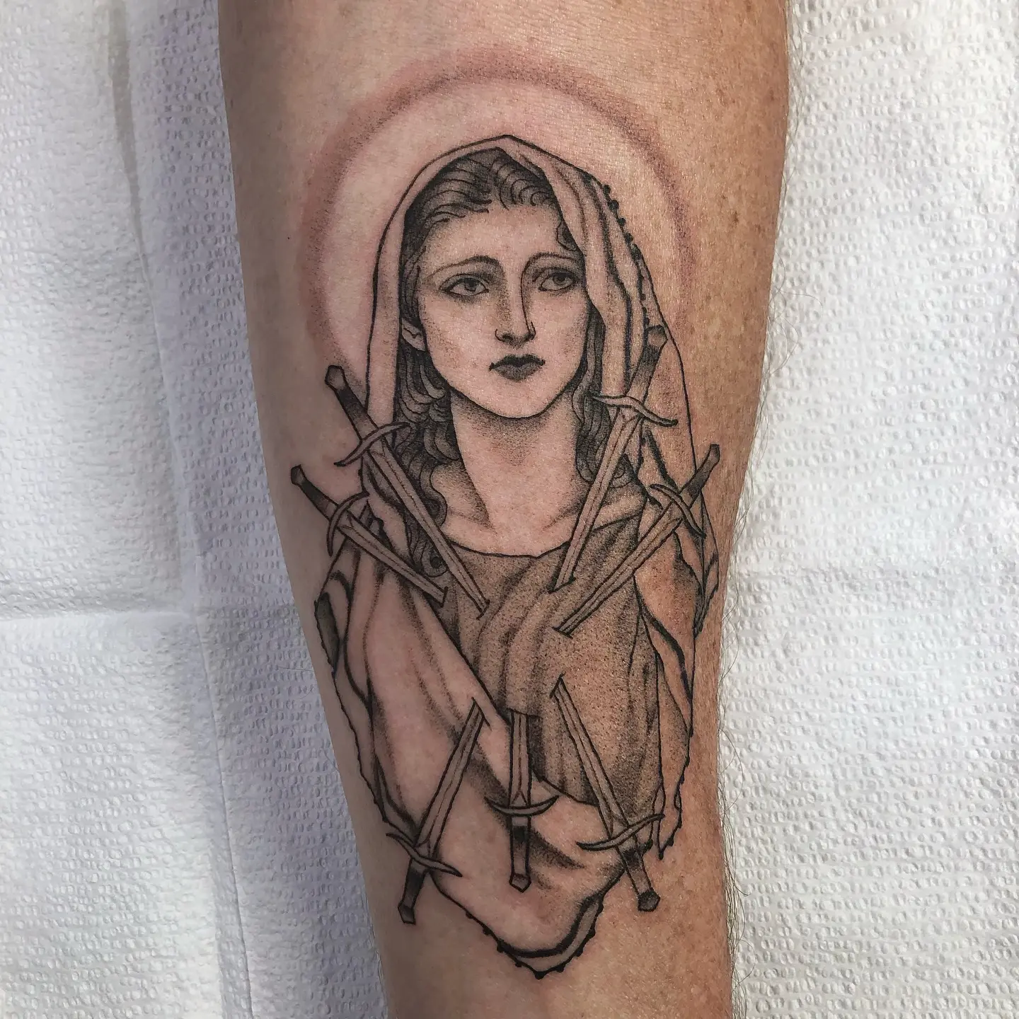 Striking Virgin Mary Tattoo Surrounded by Swords
