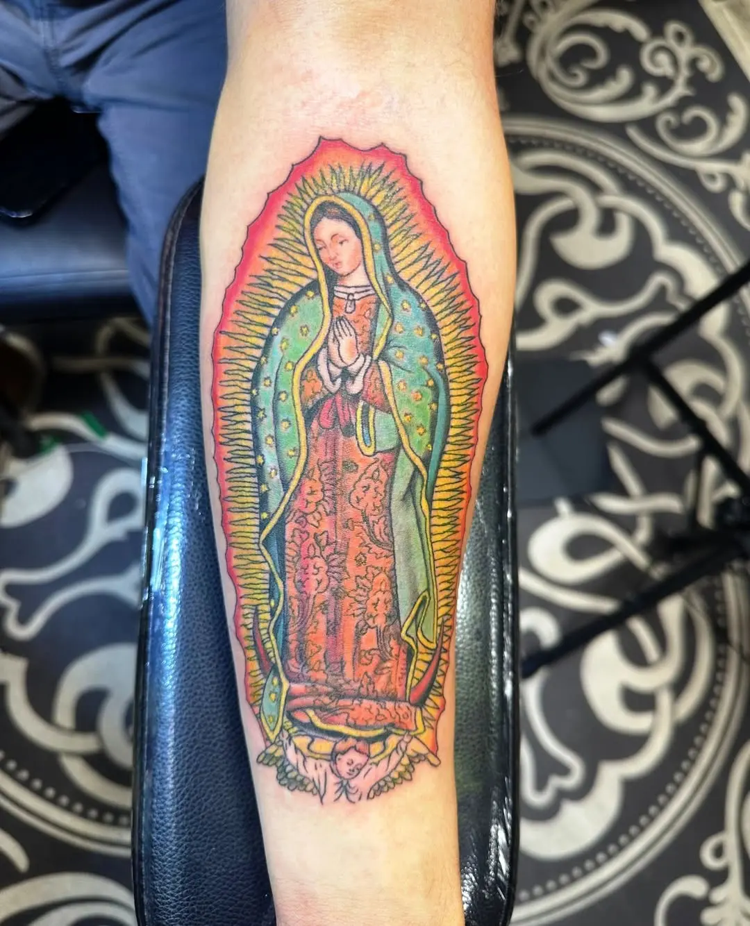 Vibrant Virgin Mary Tattoo with Floral Elements