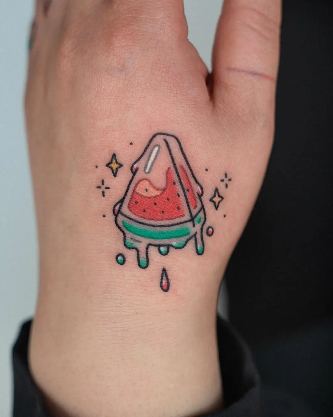 Vibrant watermelon tattoo on the hand