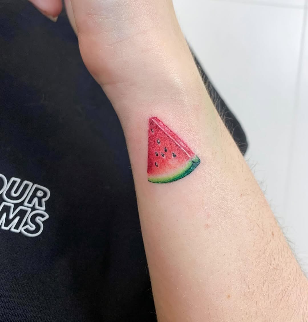 Colorful watermelon slice tattoo on the arm