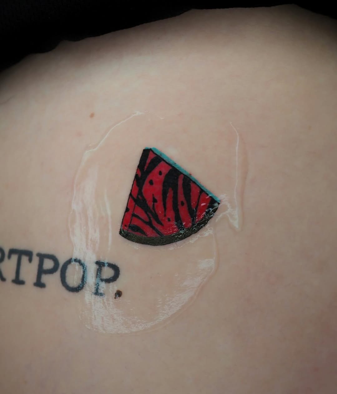Vibrant watermelon tattoo with artistic flair