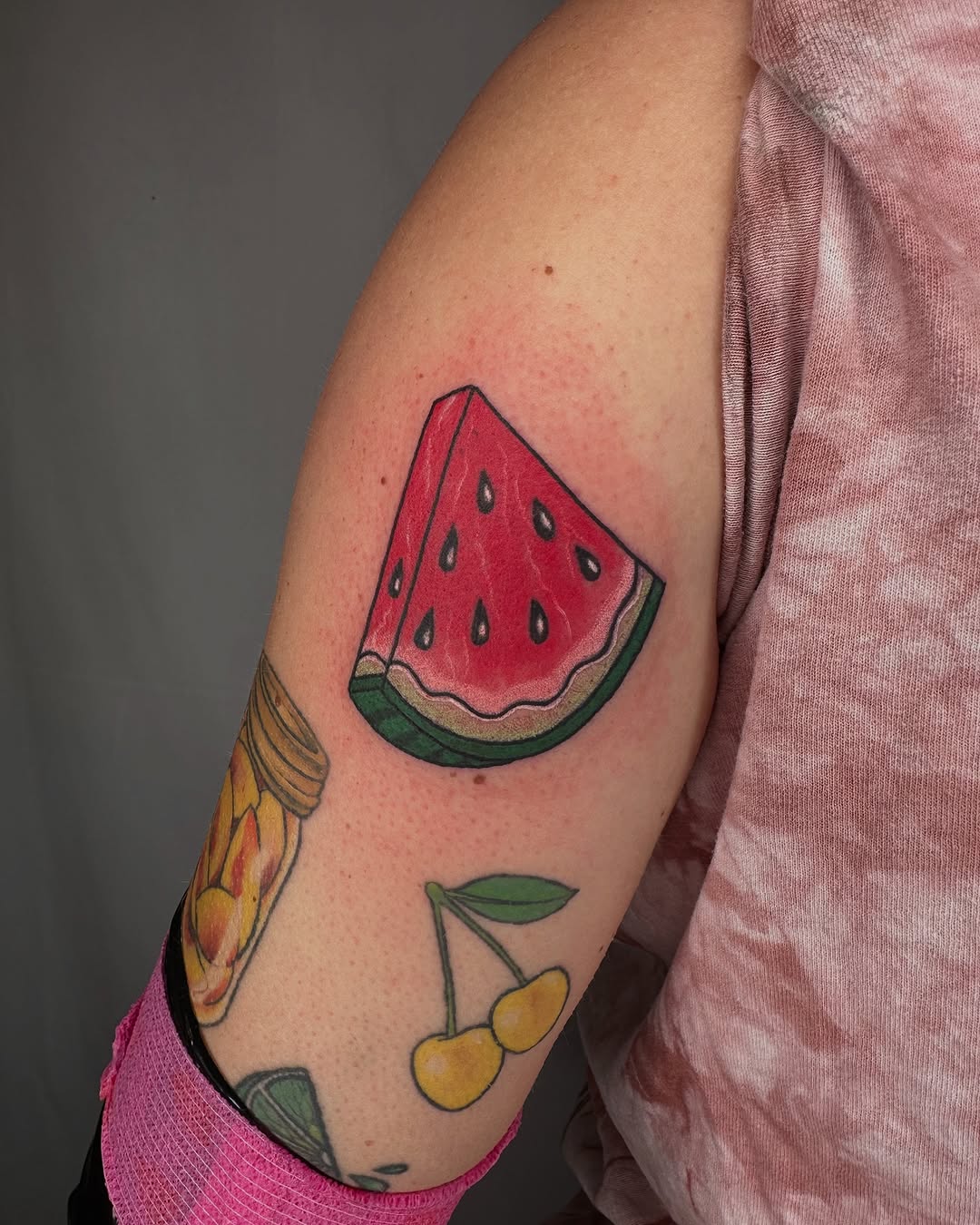 Vibrant watermelon slice tattoo on the arm