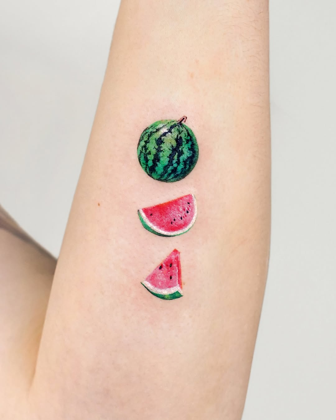Charming watermelon slices tattoo design with a twist