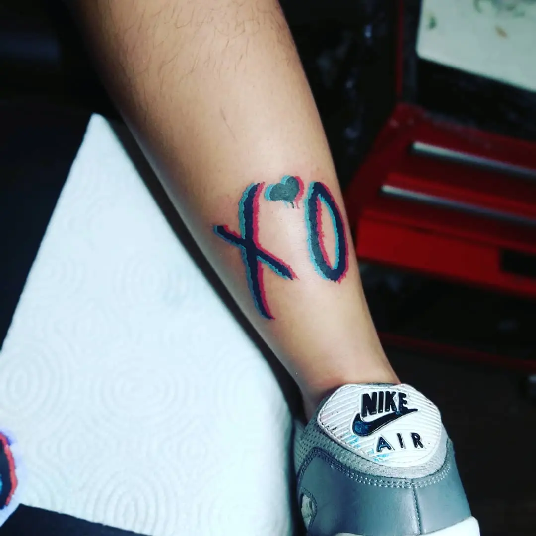 Vibrant XO Tattoo on Calf Area