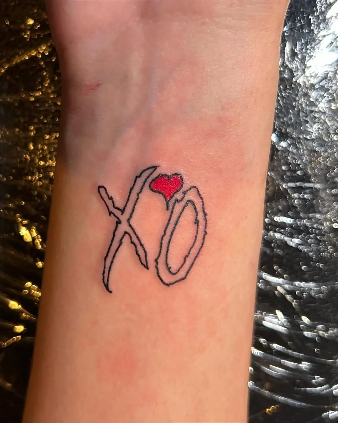 Charming XO Tattoo with Heart Accents
