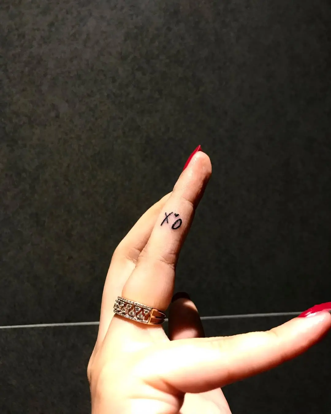 Minimalist XO Tattoo on Finger