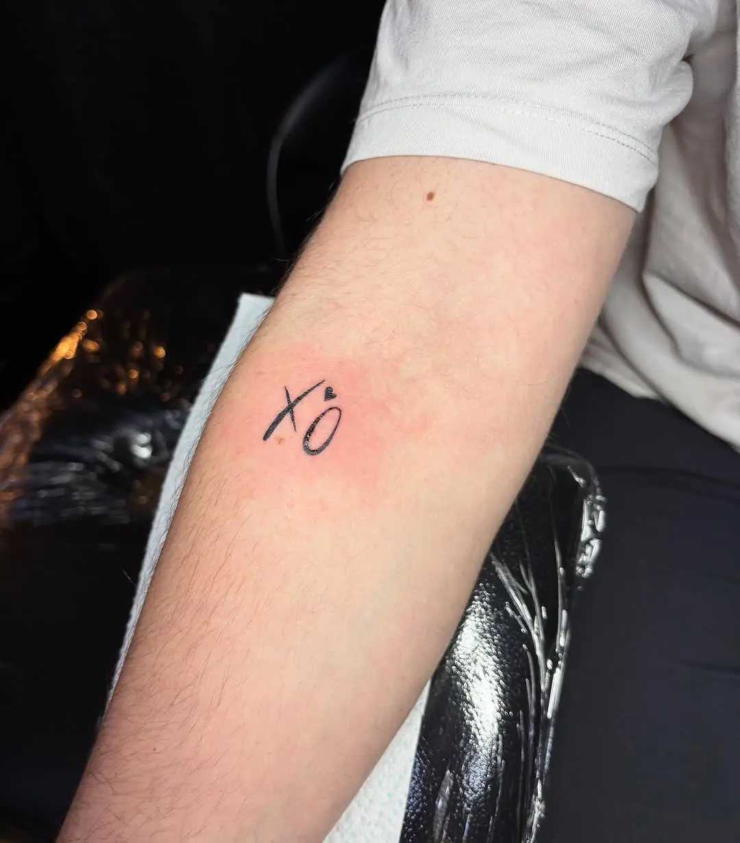 Minimalist XO Tattoo on Forearm