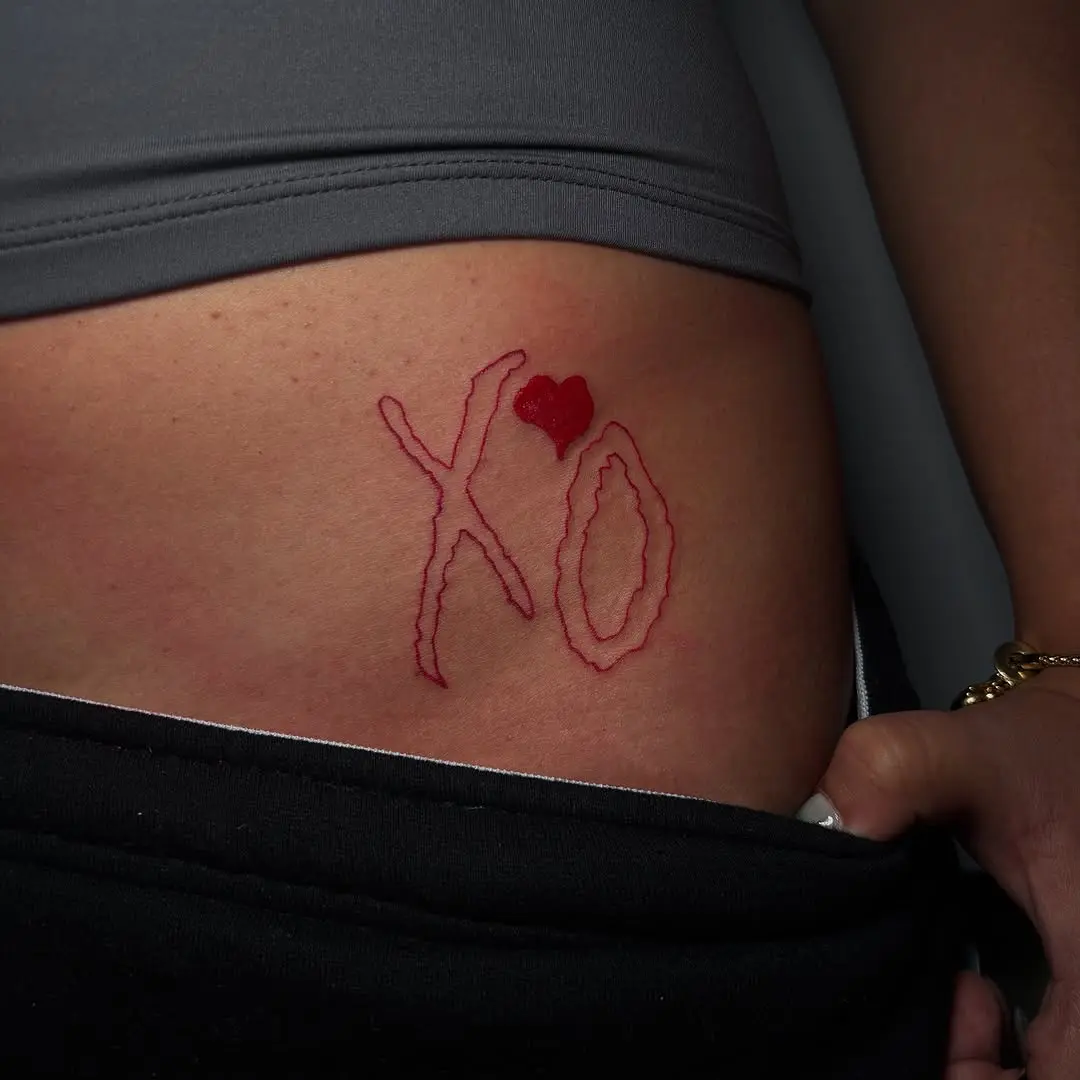 Intimate expression with striking XO tattoo