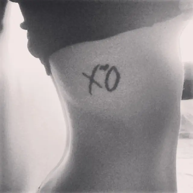 Stylized XO Tattoo on Ribcage