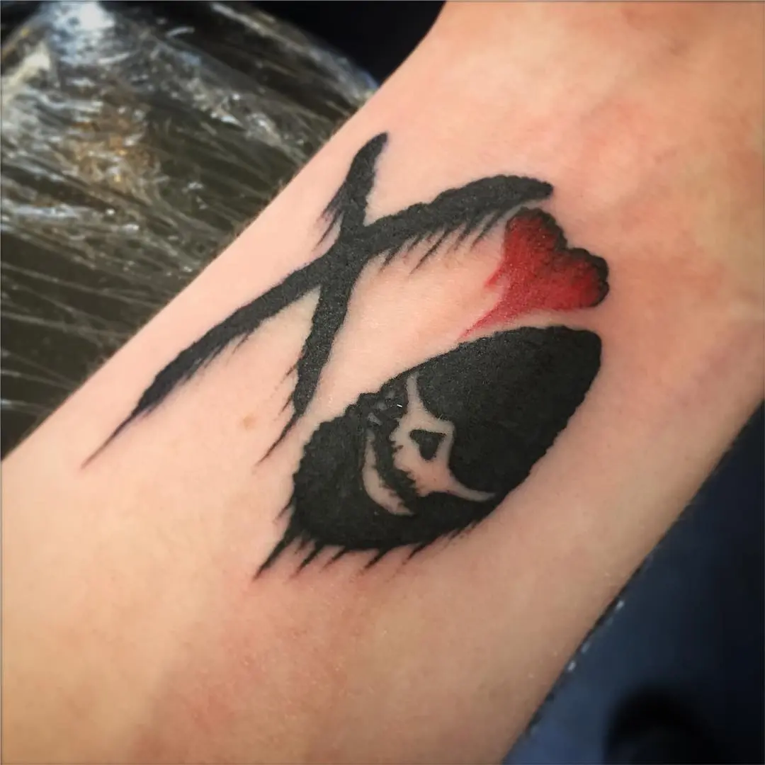 Unique xo tattoo showcasing skull and heart