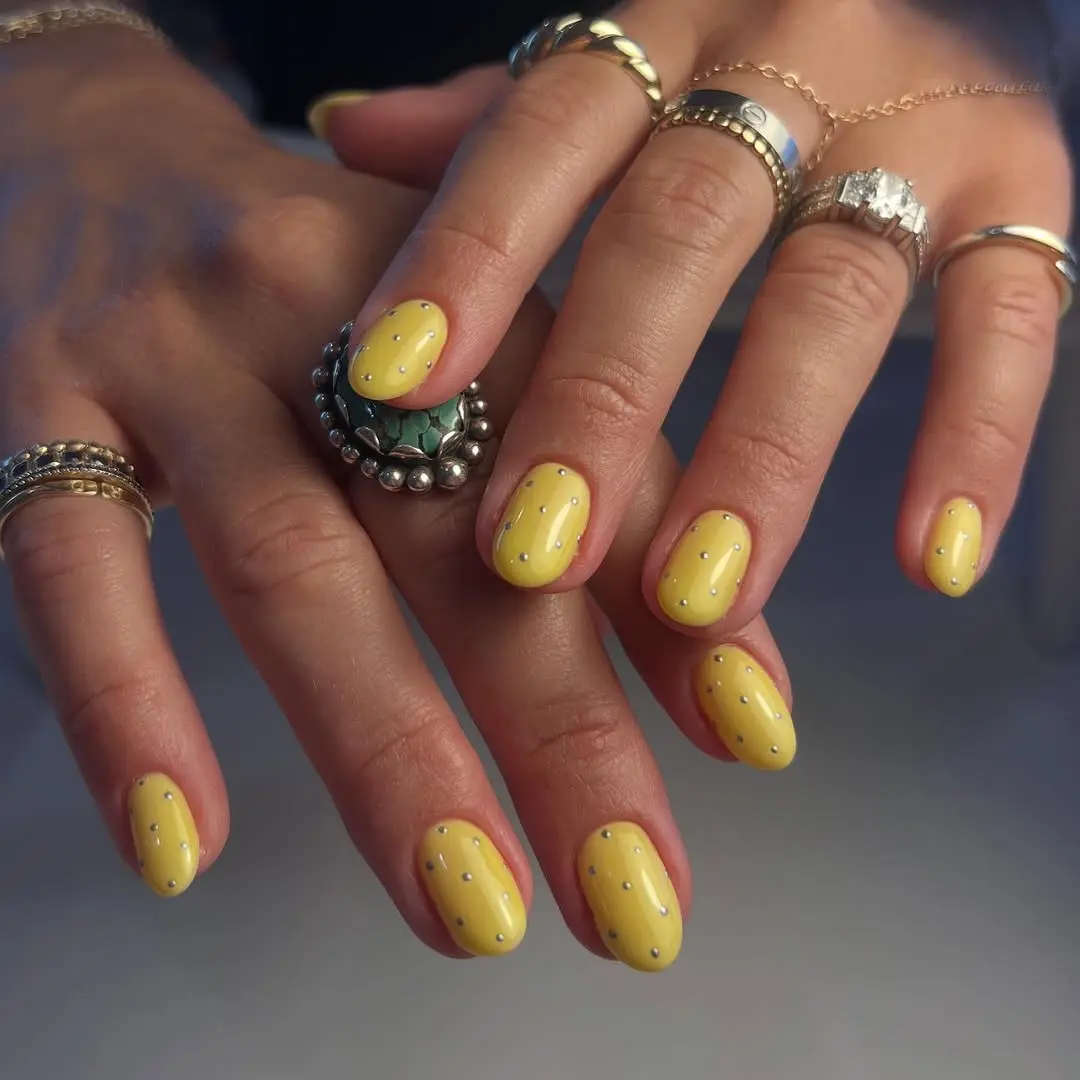 Cheerful yellow polka dot nail art design