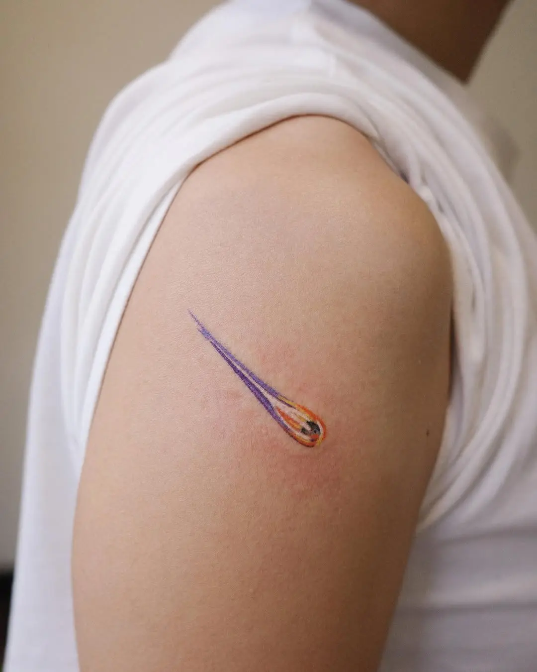 Vibrant meteor tattoo design on arm