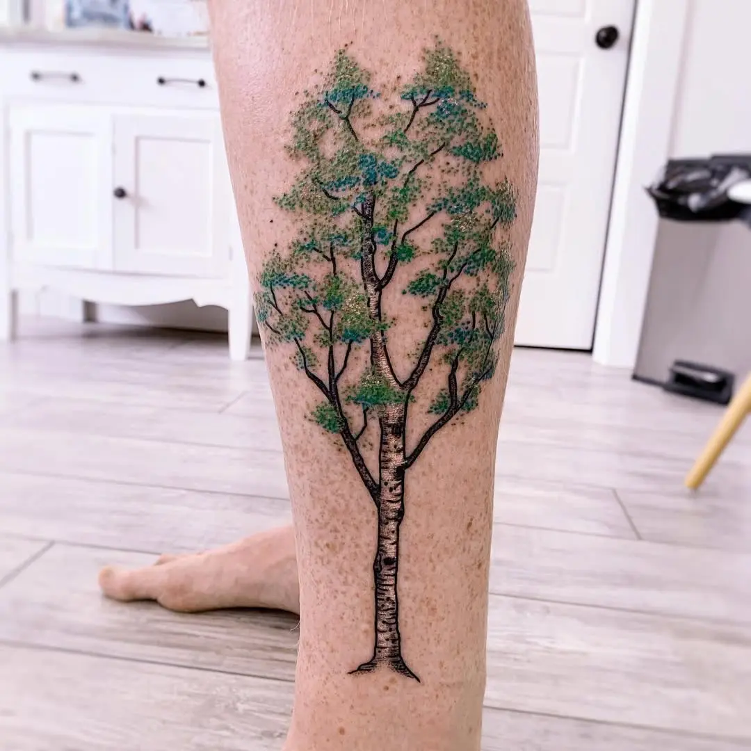 Vibrant birch tree tattoo with rich details