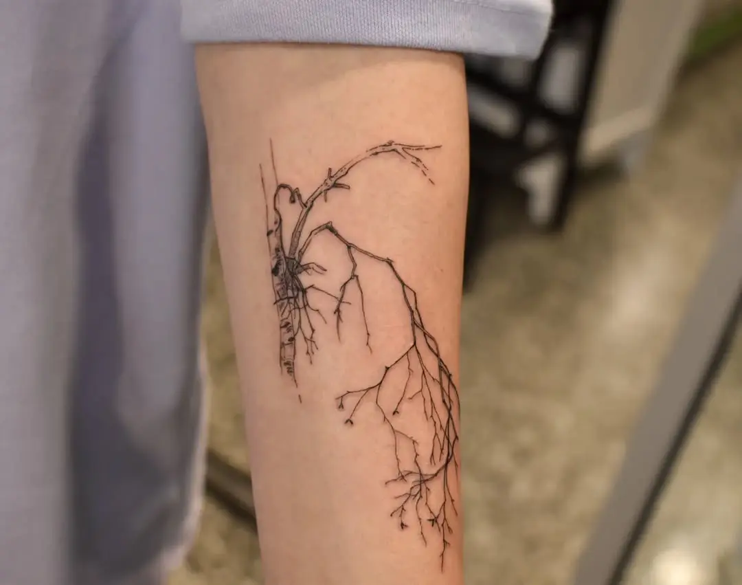 Intricate birch tree roots tattoo design