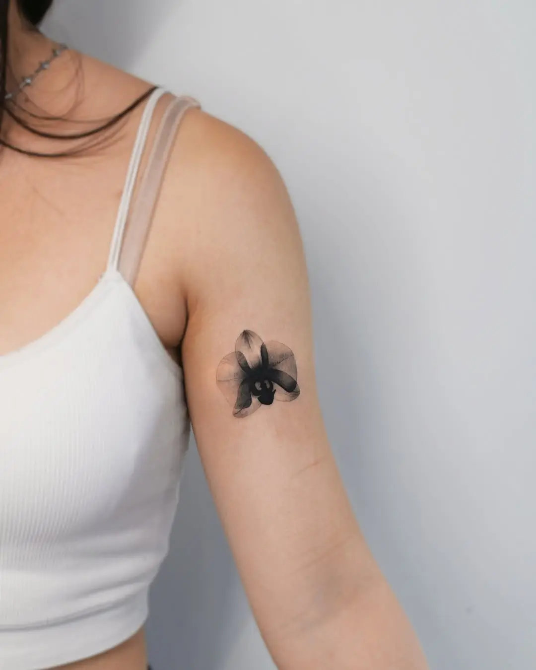 Stunning black orchid tattoo on the arm
