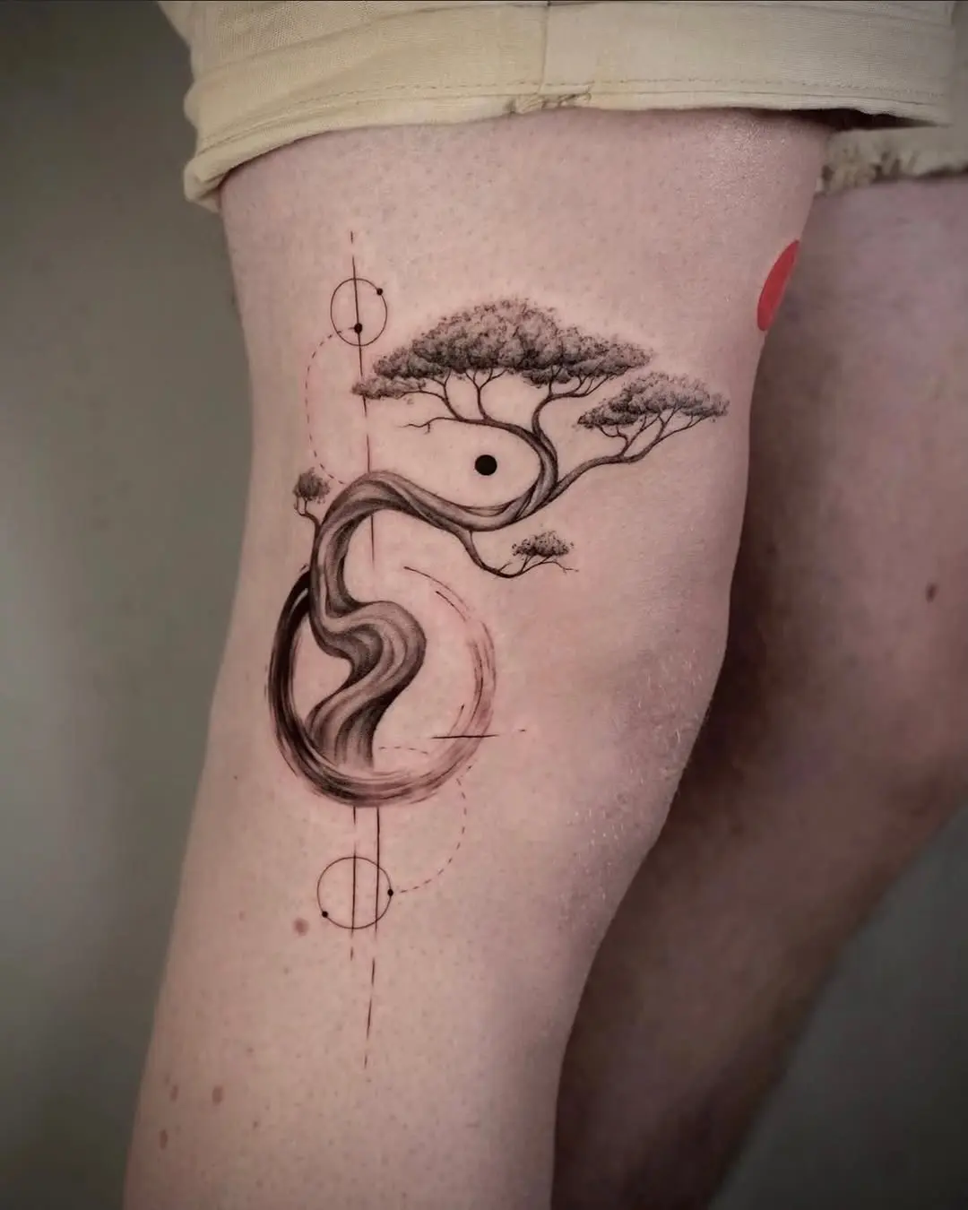 Elegant bonsai tattoo wrapping around the knee