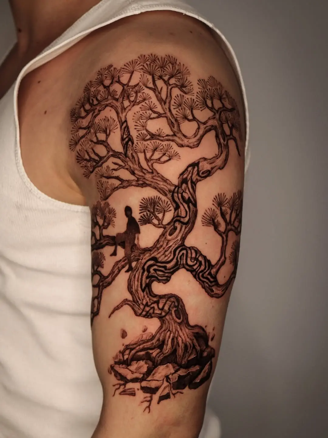 Intricate bonsai tree sleeve tattoo showcases artistry