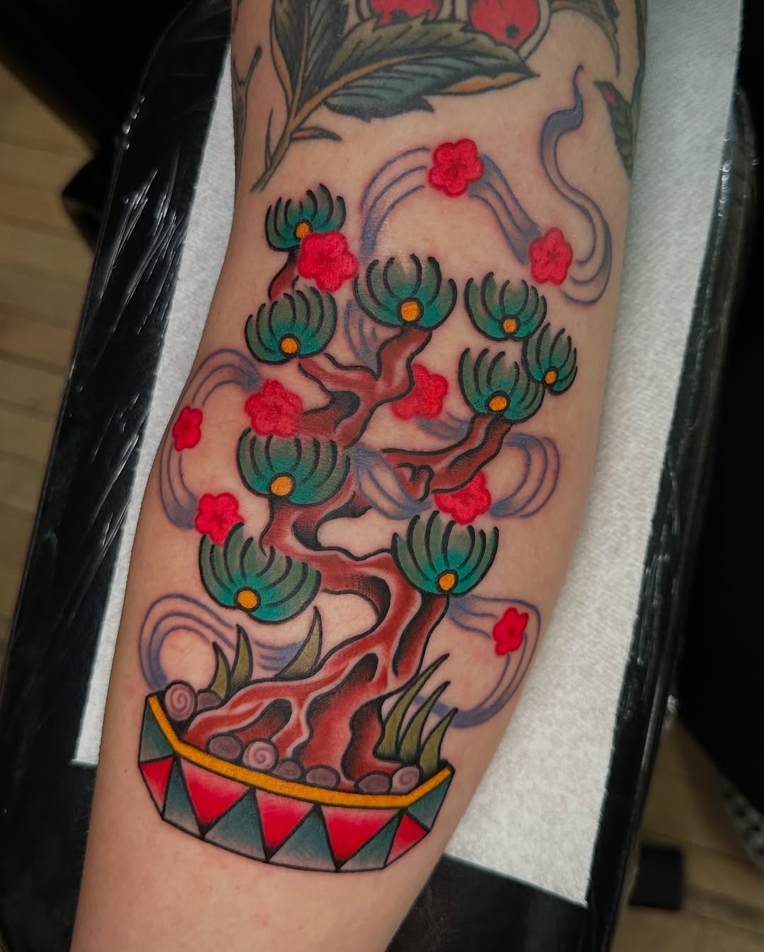 Vibrant Bonsai Tattoo with Floral Accents