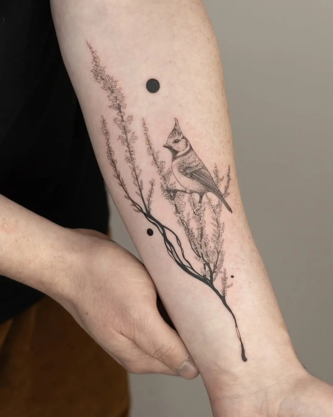 Elegant black branch tattoo with a bird