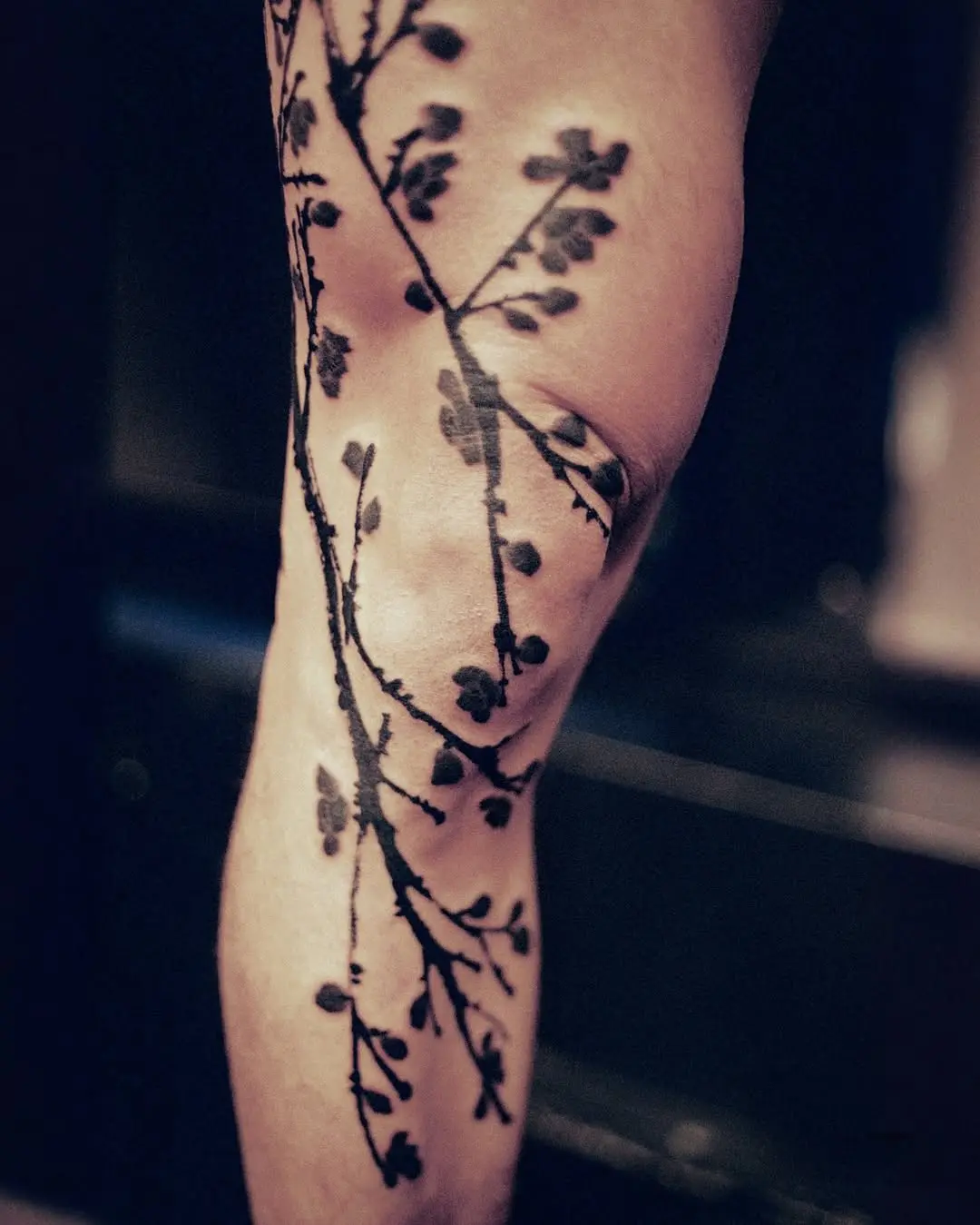 Elegant black ink branch tattoo design
