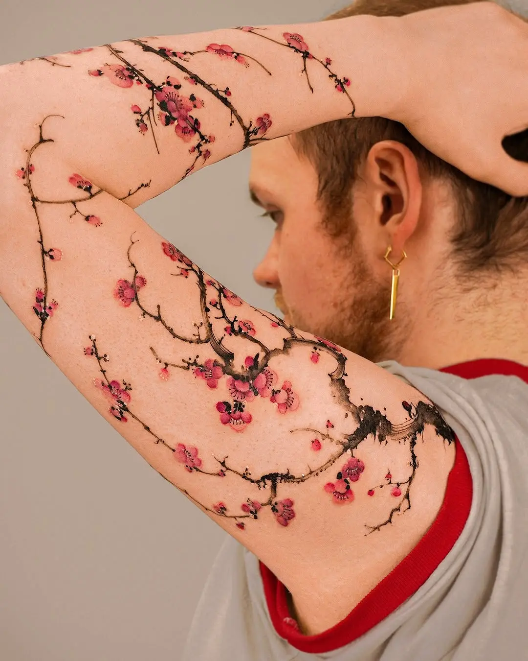 Stunning cherry blossom branch tattoo design