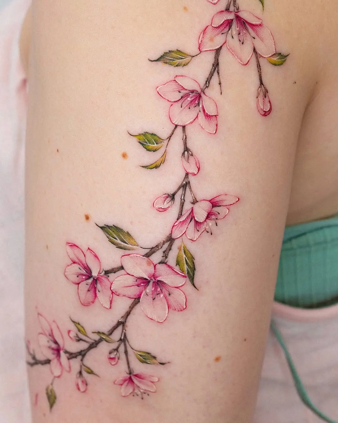 Delicate floral branch tattoo on skin