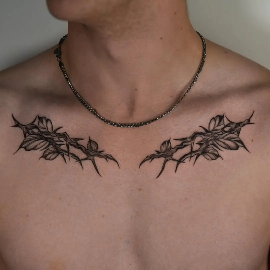 Intricate branch tattoo design across the chest