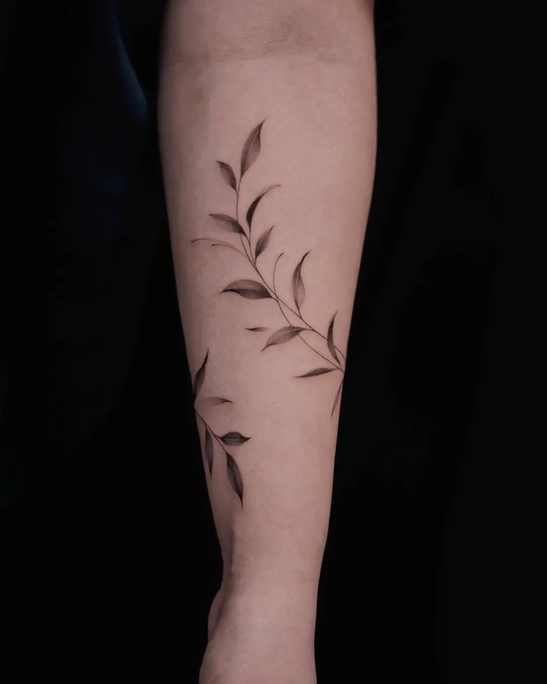 Elegant leaf design tattoo on the forearm
