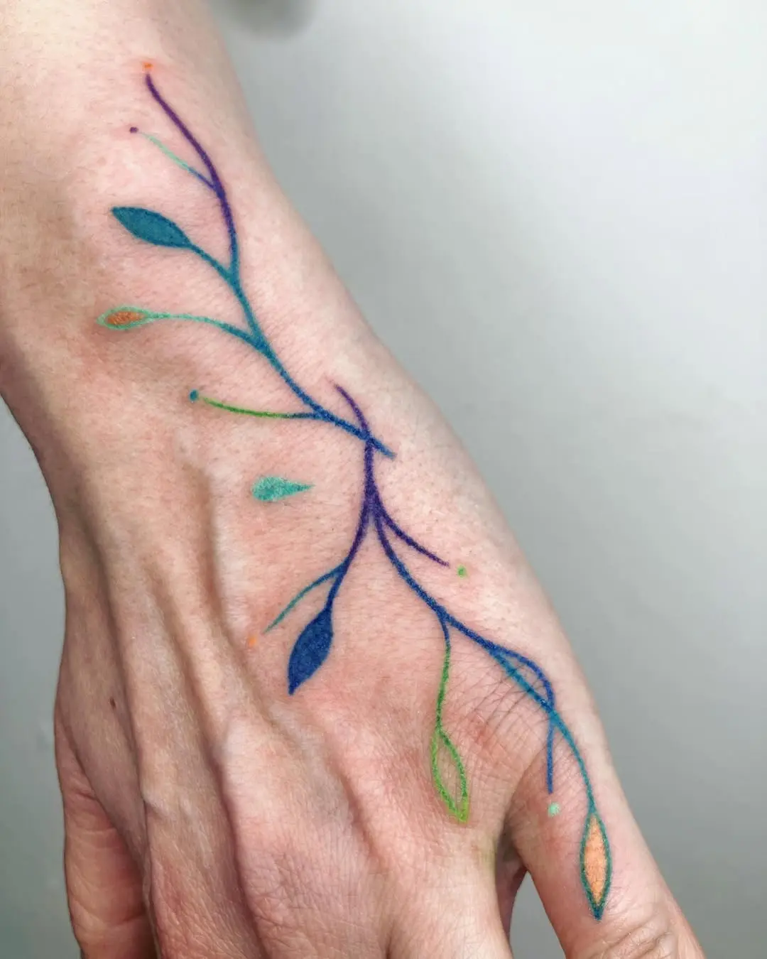 A Colorful Branch Tattoo on the Forearm