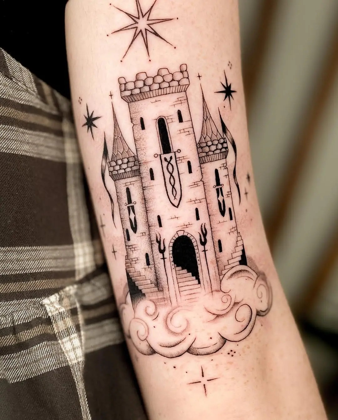 Majestic castle tattoo surrounded by whimsical clouds