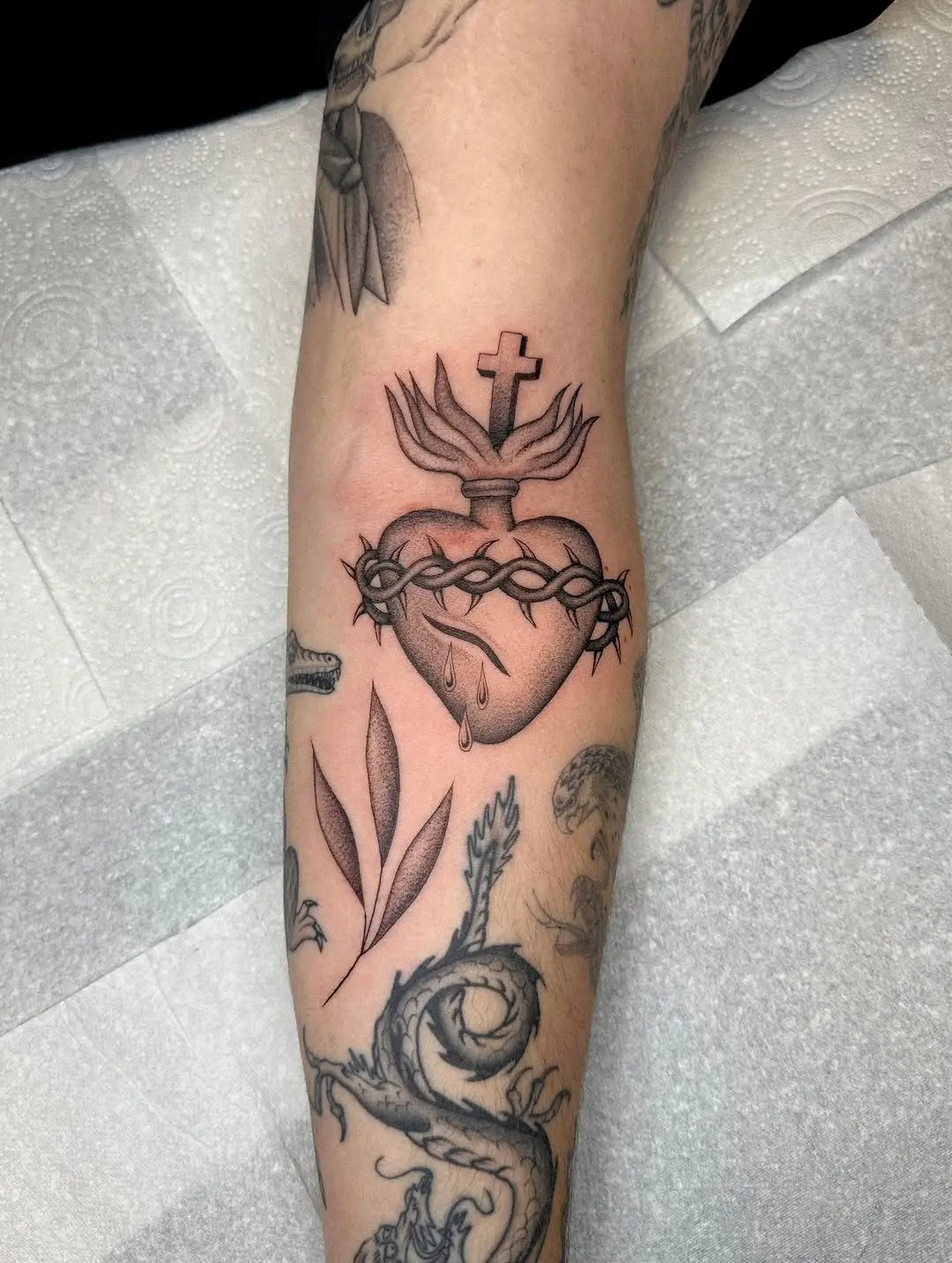 Elegant faith-inspired heart and cross tattoo