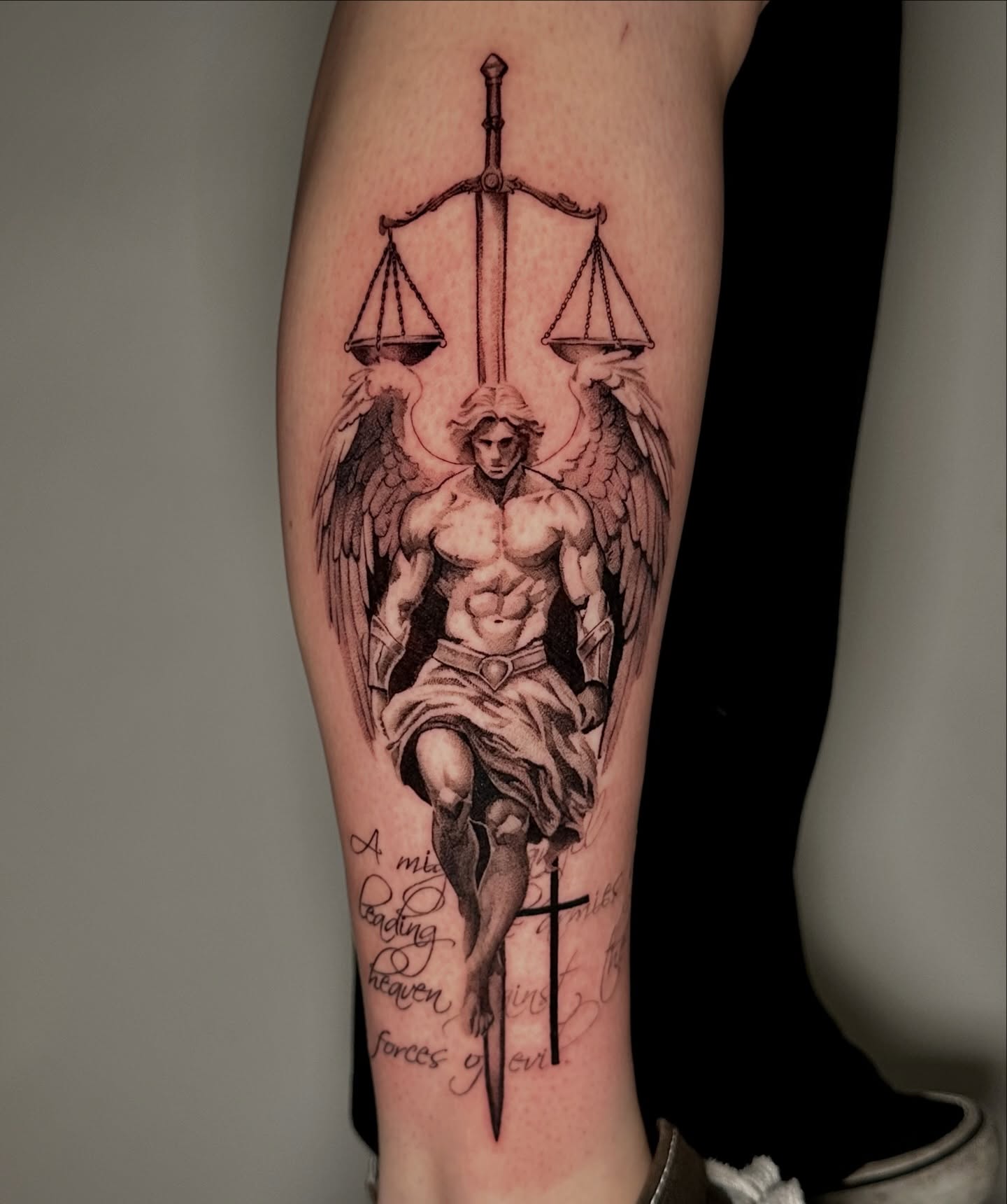 Powerful angel tattoo symbolizing justice and faith