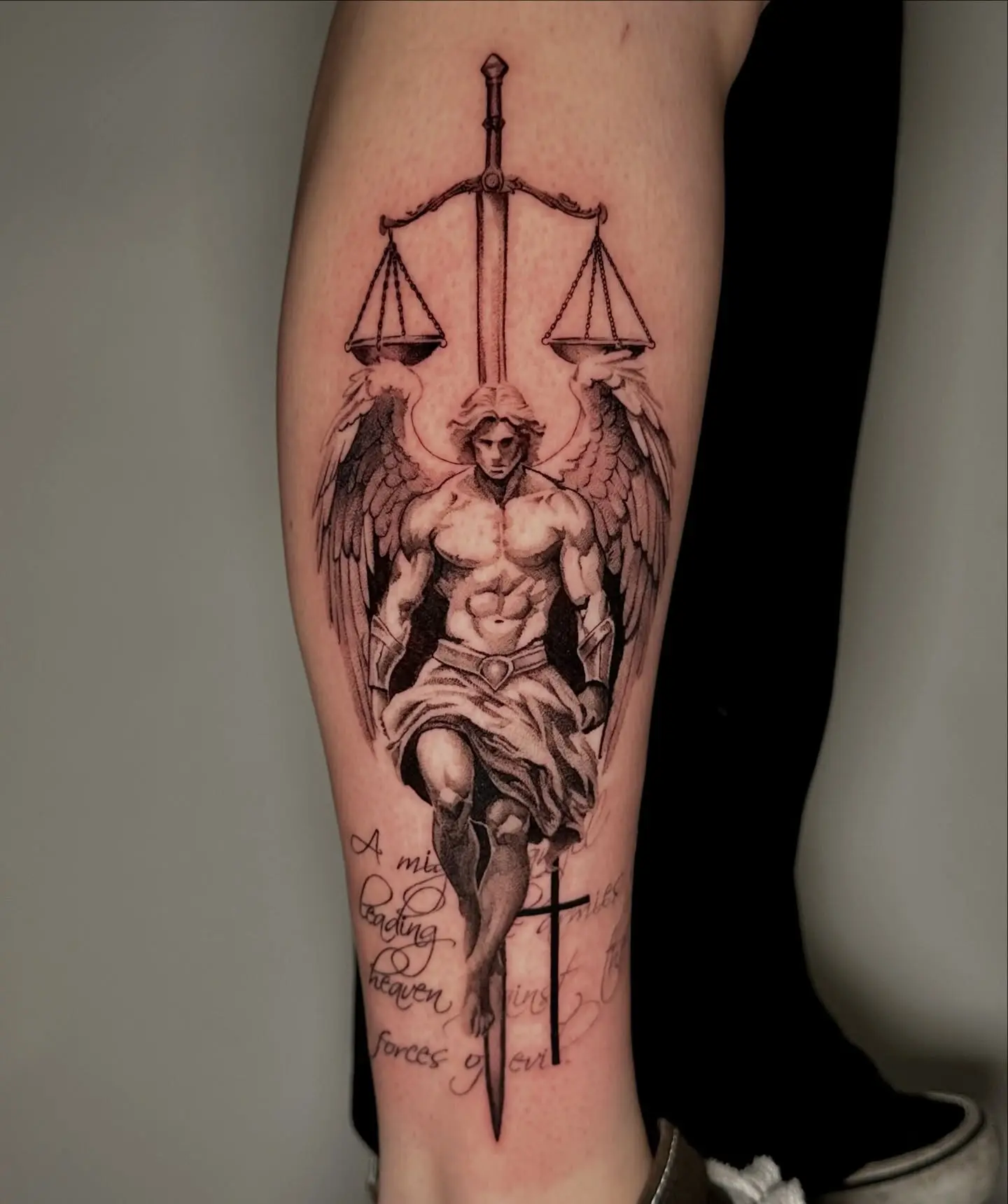 Powerful angel tattoo symbolizing justice and faith