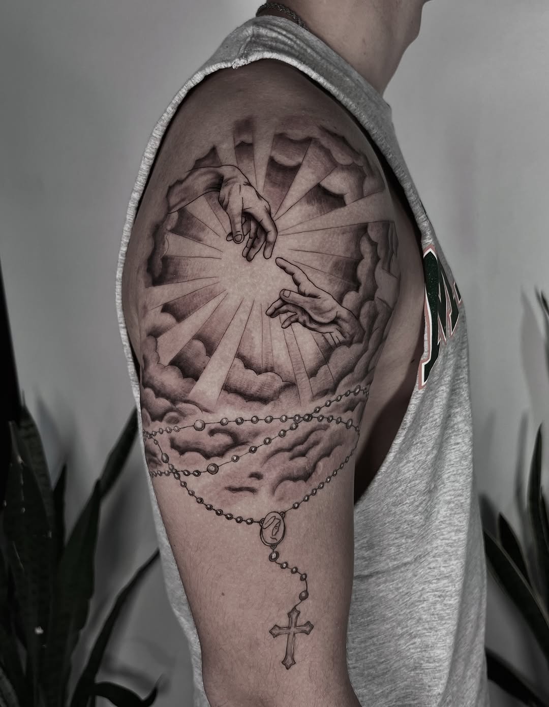 Dramatic hands reaching through clouds tattoo