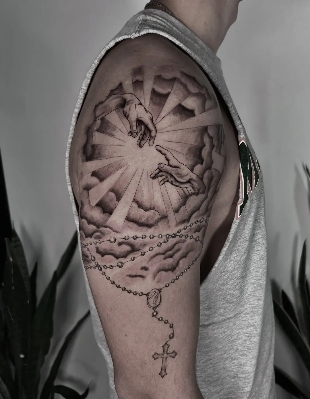 Dramatic hands reaching through clouds tattoo