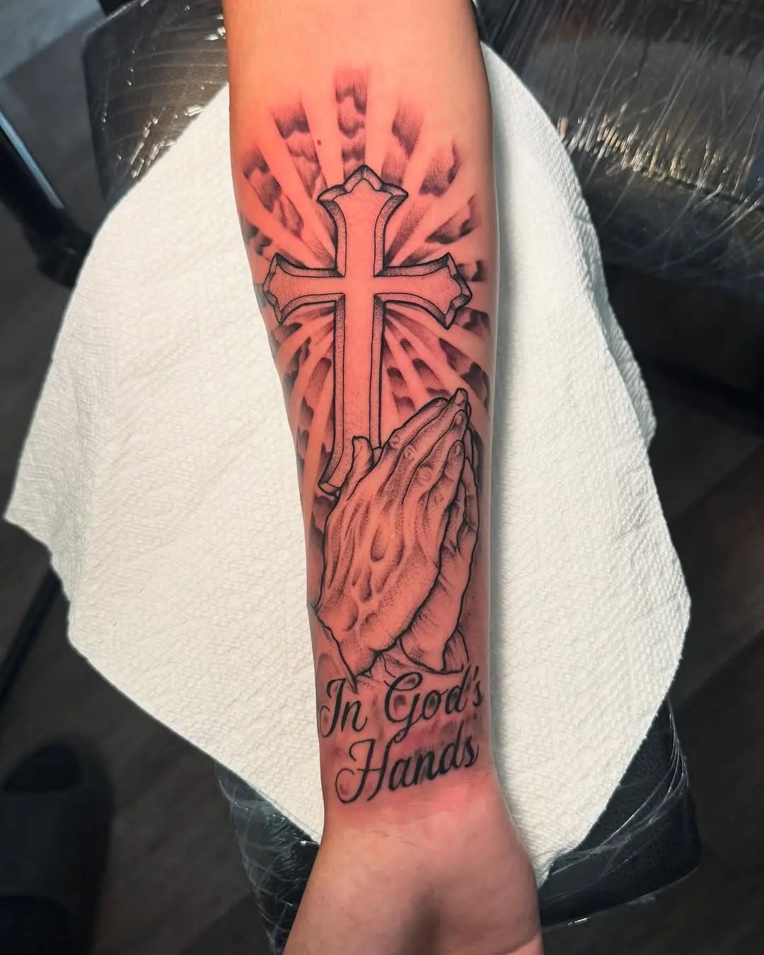 Faith symbolized through prayerful hands and cross