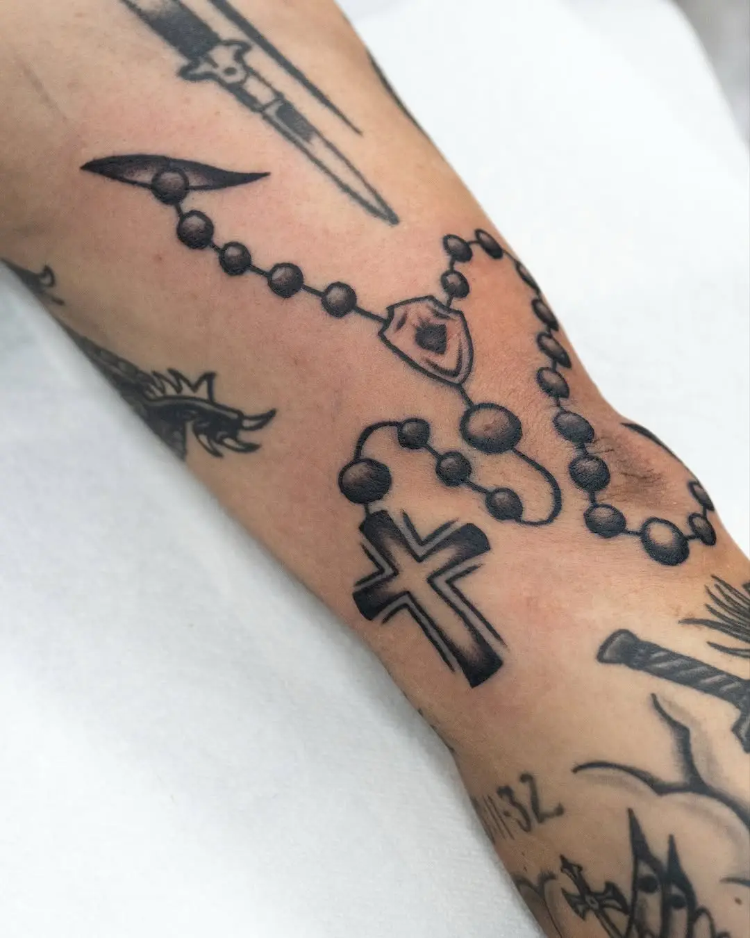 Elegant Rosary Tattoo with Cross Design